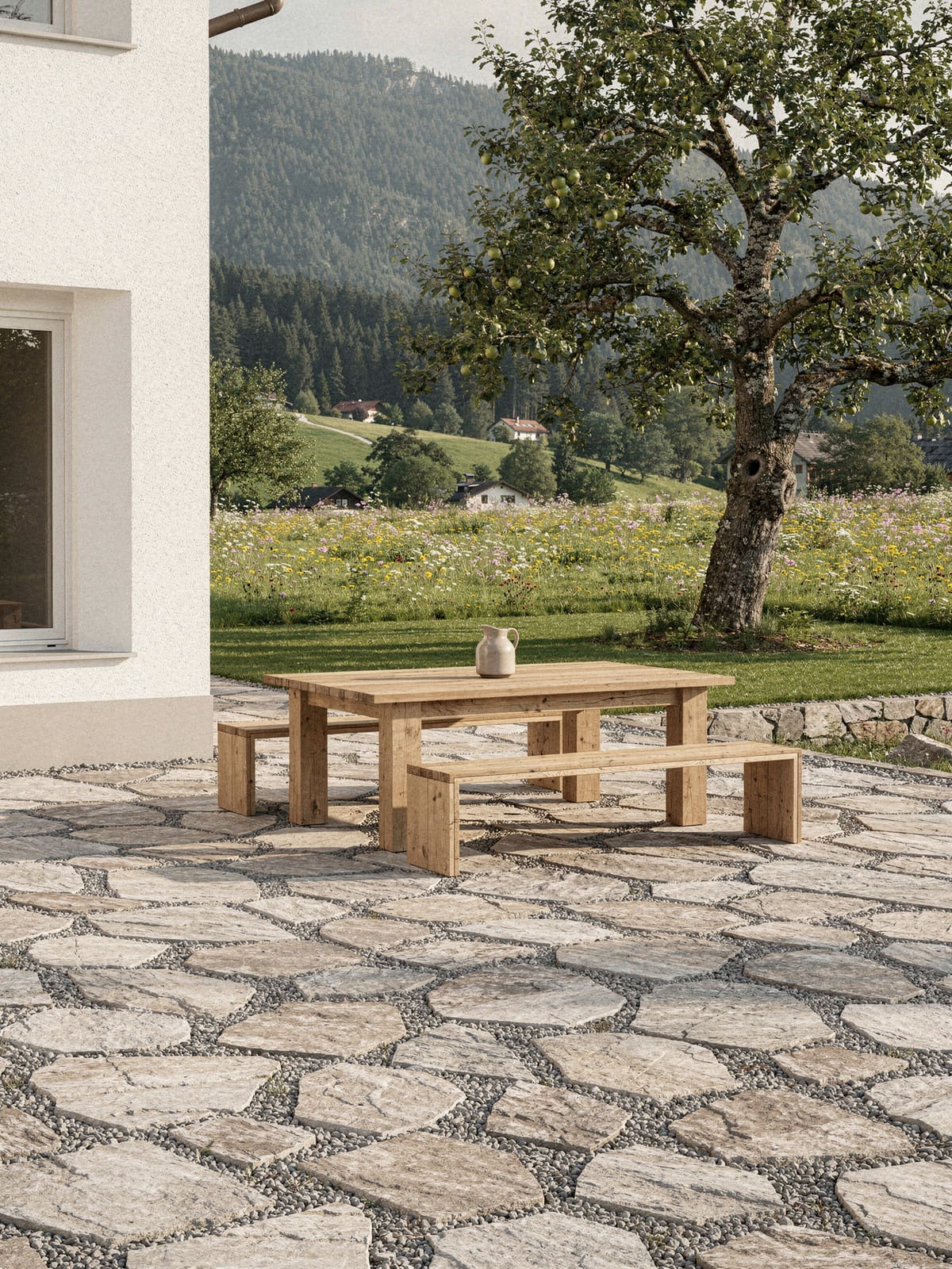 Gartenterrasse eines Landhauses mit Polygonalplatten aus Naturstein und Blick auf die Voralpen